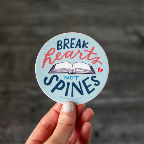 Break hearts, not spines! A sticker for book lovers. 3-inch round, weatherproof vinyl with hand lettering by Em Dash Paper Co.