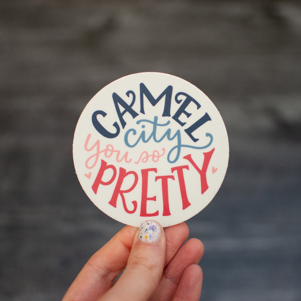 Camel City, you so pretty. Hand-lettered design by Em Dash Paper Co. Round, 3-inch diameter, weather-resistant vinyl.