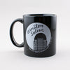 Winston-Salem: the city that's always happy to see you. Black ceramic mug with white print, by Em Dash Paper Co.